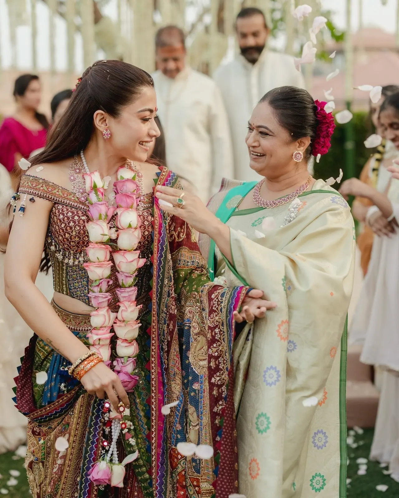 Vijay's mother and Rashmika's mother-in-law, makes sure her daughter-in-law looks her best as she fixes her dupatta in this candid picture.