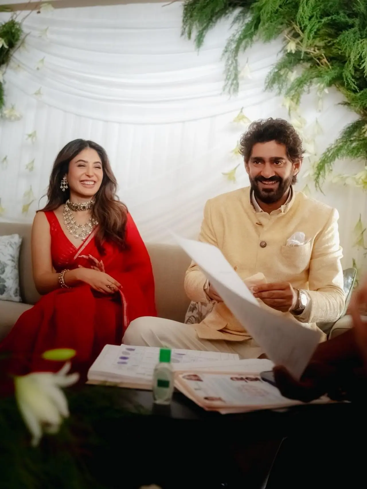 This picture is from their civil ceremony as they sign the documents and legally register their marriage.