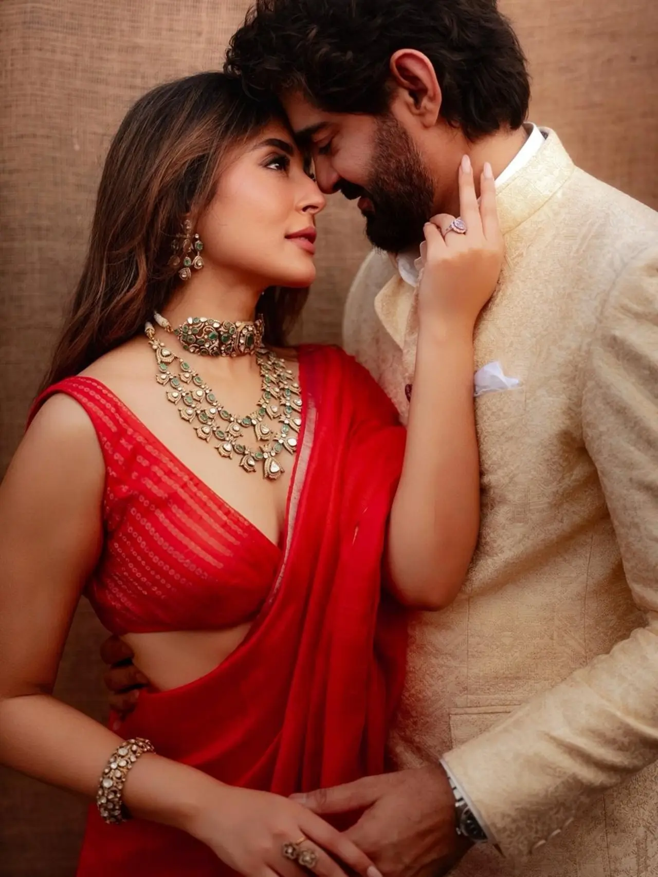 The couple embrace each other in this intimate and romantic photo, standing close as if lost in each other's eyes.