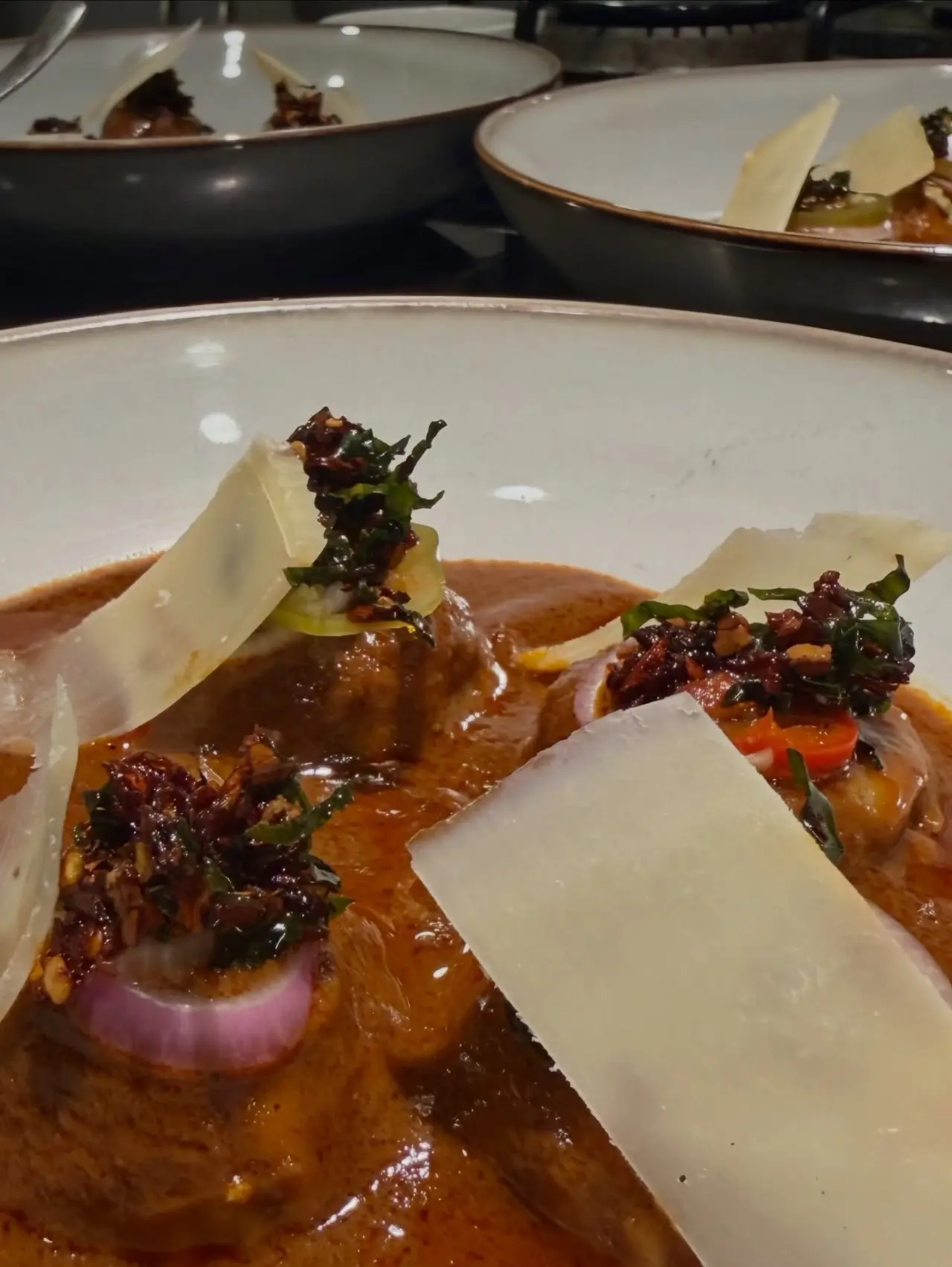 Another delicious dish on the menu was what seemed like meat dipped in red spicy sauce and garnished with thinly shaved cheese or Parmesan crisps.