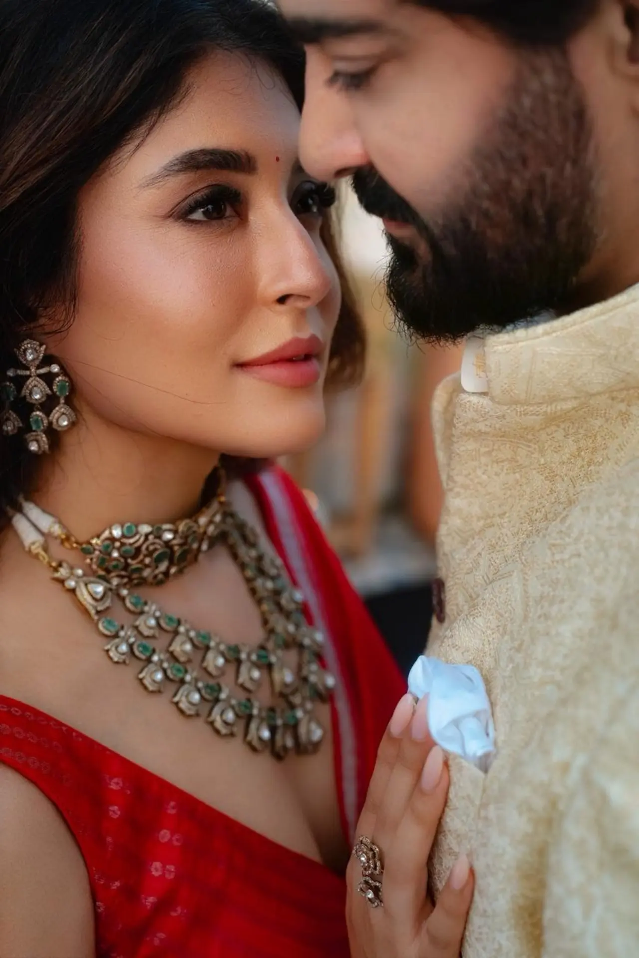 Gaurav and Kritika look deep into each other's eyes while standing close to each other in this romantic picture.