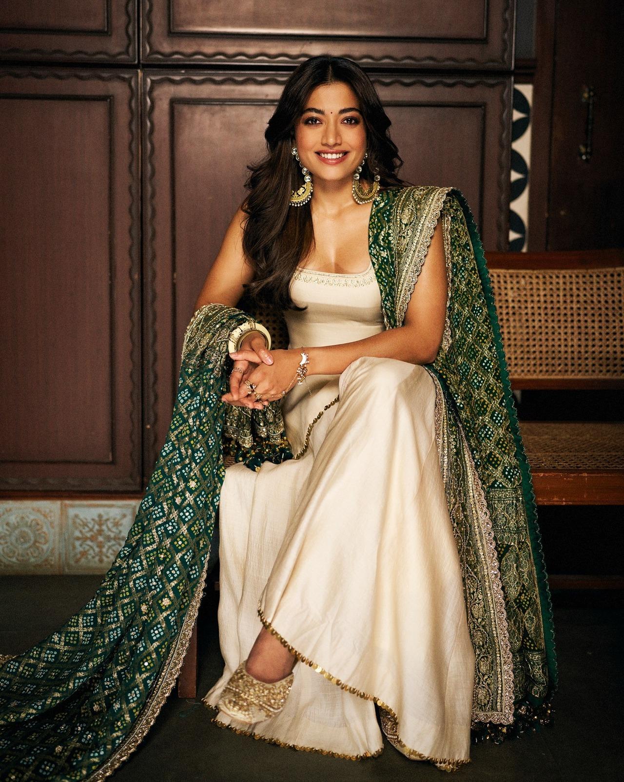 Rashmika Mandanna exudes royalty in this ivory sharara set paired with a green bandhani Banarasi dupatta. 