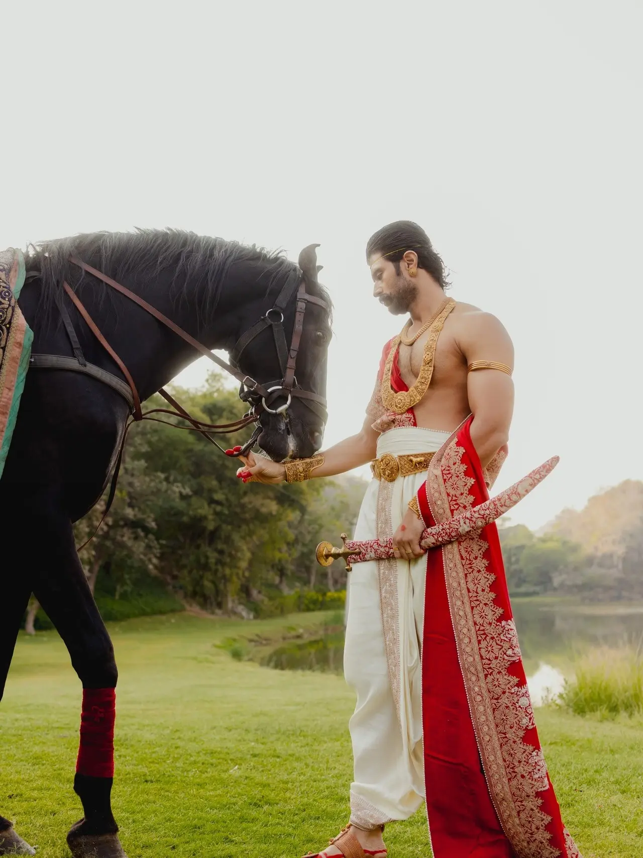 Vijay Deverakonda exudes royal king vibe in this candid picture, dressed in his wedding attire with his horse, while holding a sword in his hand.