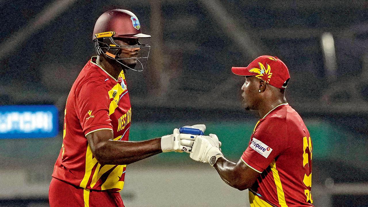 WI’s Jason Holder (left) and Rovman Powell during their unbeaten 76-run stand. Pic/PTI