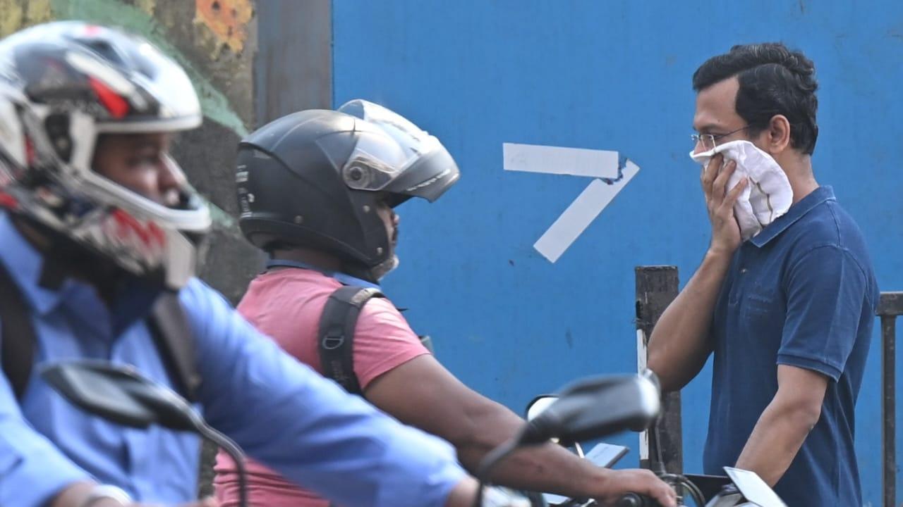 Pedestrians were also seen covering their faces to avoid the dust