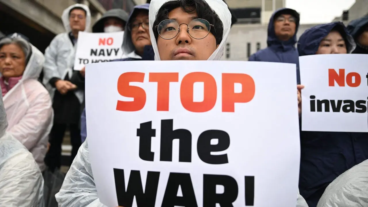 South Korean protesters hold placards during a rally near the US embassy in Seoul on Wednesday, condemning US and Israeli strikes on Iran