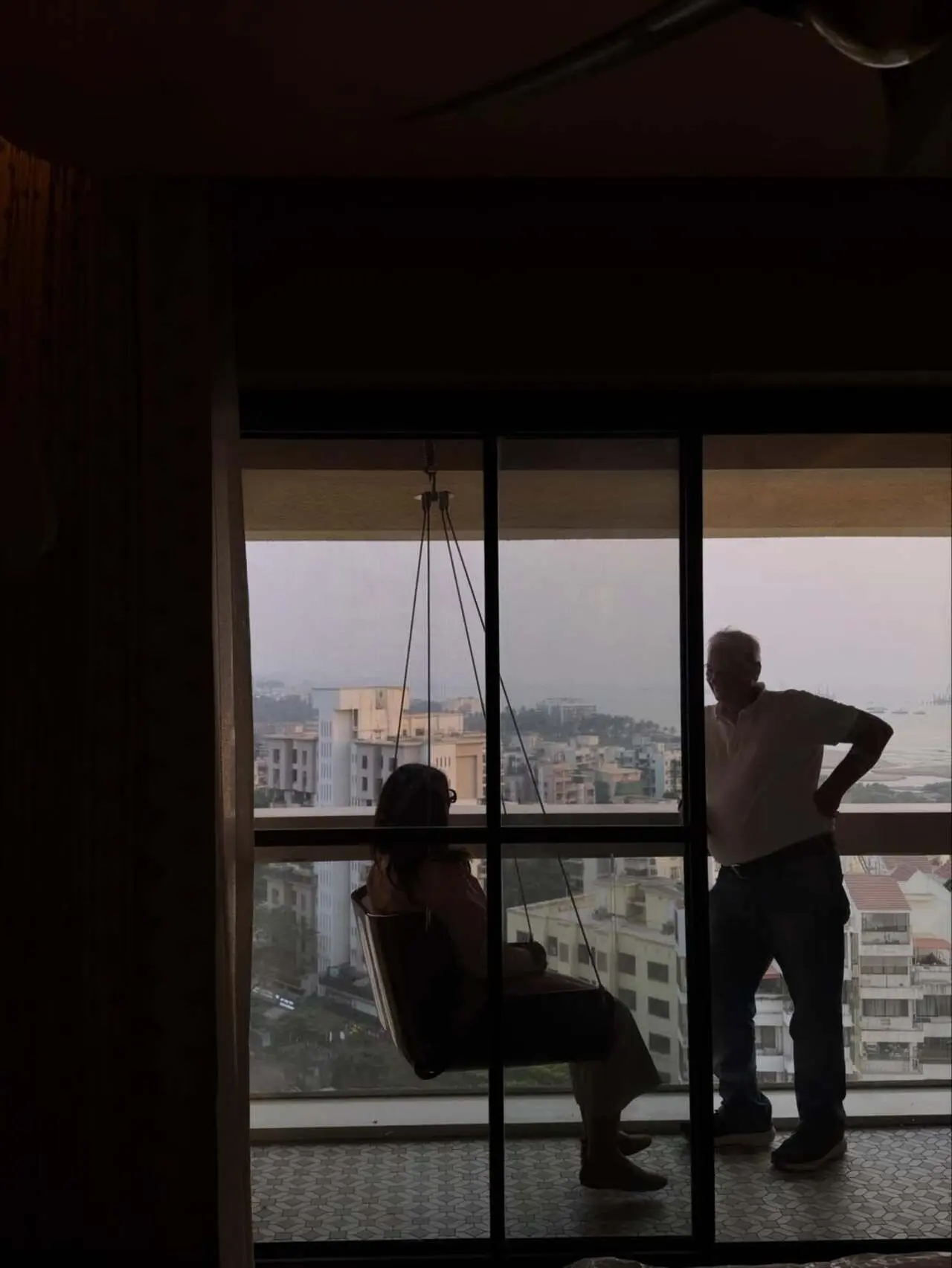 Hanging swing corner: A cozy swing seat near the window adds a relaxed lounge spot perfect for quiet moments.