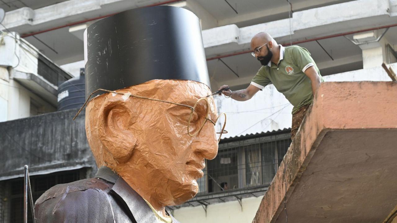 Sculptors Gitesh Pawar and Gaurav Pawar add finishing touches to the towering statue of Vinayak Damodar Savarkar, which will be a key attraction during the Girgaoncha Padwa procession in Mumbai