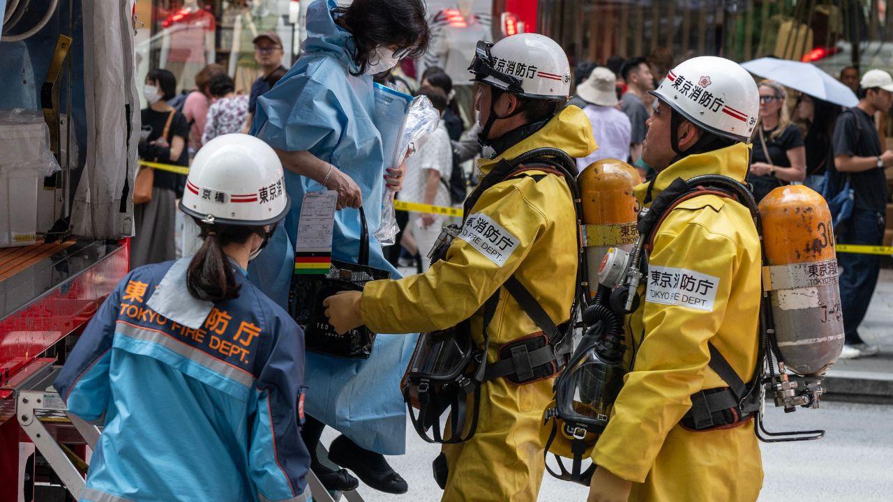 Emergency personnel help a woman, who was inside the Ginza 6 Shopping Center, out of an emergency vehicle in Tokyo after a substance was sprayed inside the mall. Pic/AFP Emergency personnel help a woman, who was inside the Ginza 6 Shopping Center, out of an emergency vehicle in Tokyo after a substance was sprayed inside the mall. Pic/AFP
