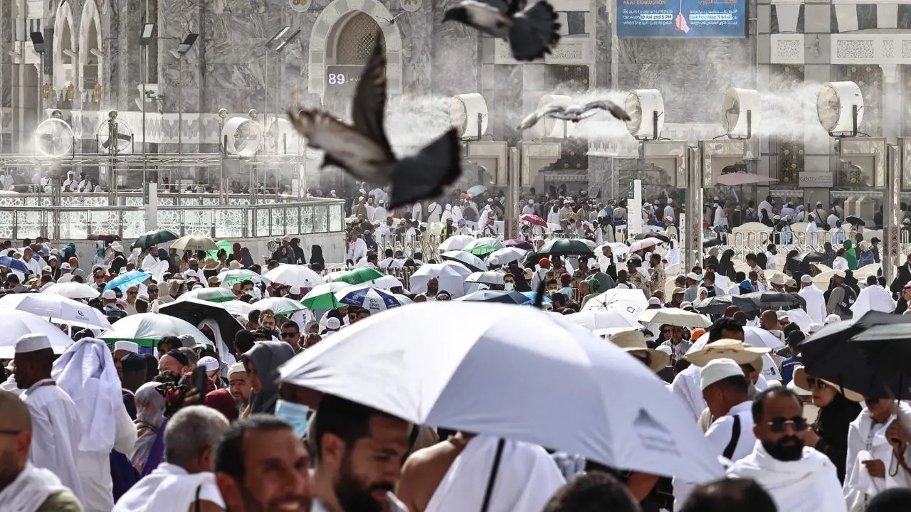 Worshippers walk through the Grand Mosque complex under misting fans as authorities work to ease extreme heat conditions Worshippers walk through the Grand Mosque complex under misting fans as authorities work to ease extreme heat conditions