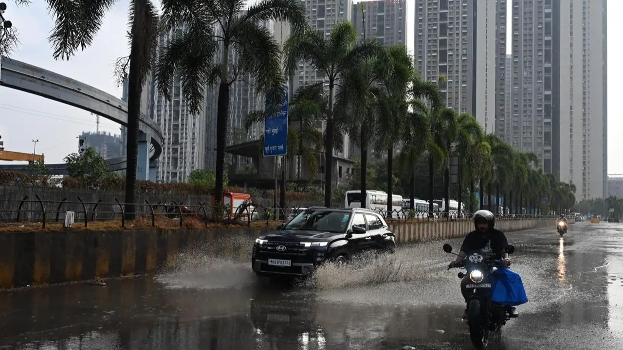 Wadala roads turn slick as heavy pre-monsoon showers hit the city, reflecting monsoon clouds and monorail tracks Wadala roads turn slick as heavy pre-monsoon showers hit the city, reflecting monsoon clouds and monorail tracks