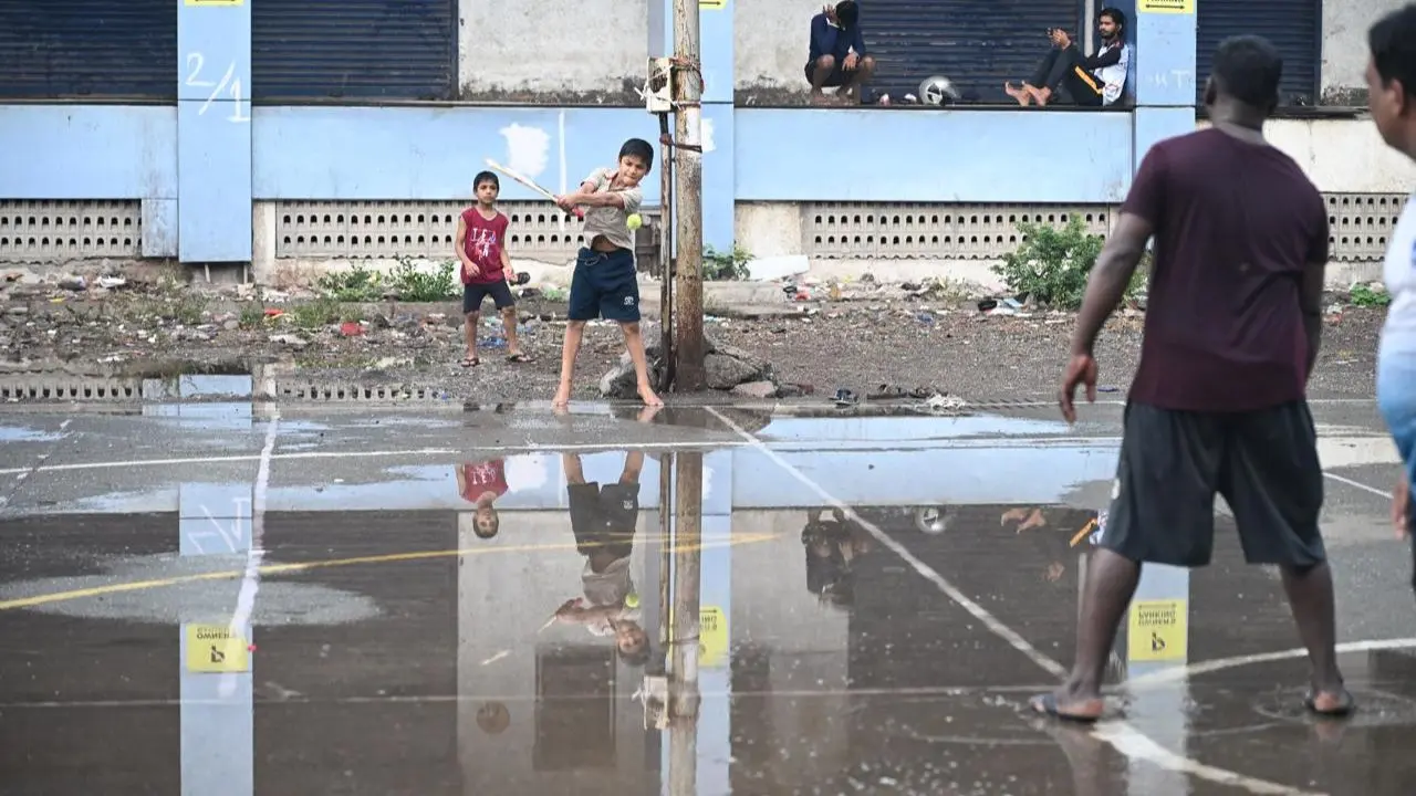 Sudden downpour in Sion and Wadala creates mirror-like reflections on ground as children play, marking early monsoon activity Sudden downpour in Sion and Wadala creates mirror-like reflections on ground as children play, marking early monsoon activity