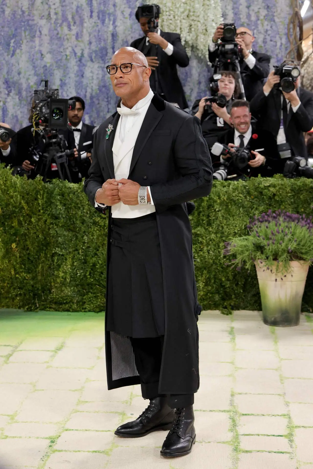 Dwayne Johnson rocked a tuxedo with a pleated skirt, custom-made by none other than Thom Browne. he showed off his Jacob &amp; Co. Billionaire III on the red carpet, a rectangular skeleton watch made from 18-carat white gold that is literally covered in diamonds.