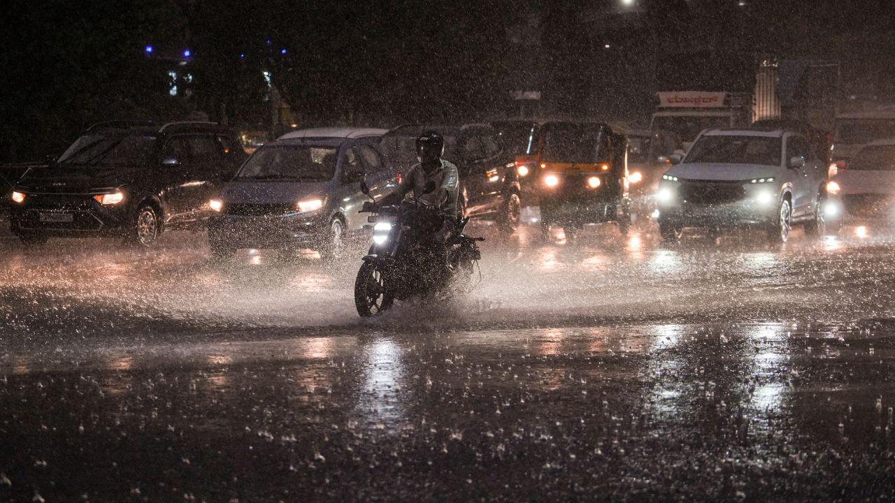 Office-goers and pedestrians wade through waterlogged streets in Bengaluru amid intense monsoon showers disrupting normal movement Office-goers and pedestrians wade through waterlogged streets in Bengaluru amid intense monsoon showers disrupting normal movement