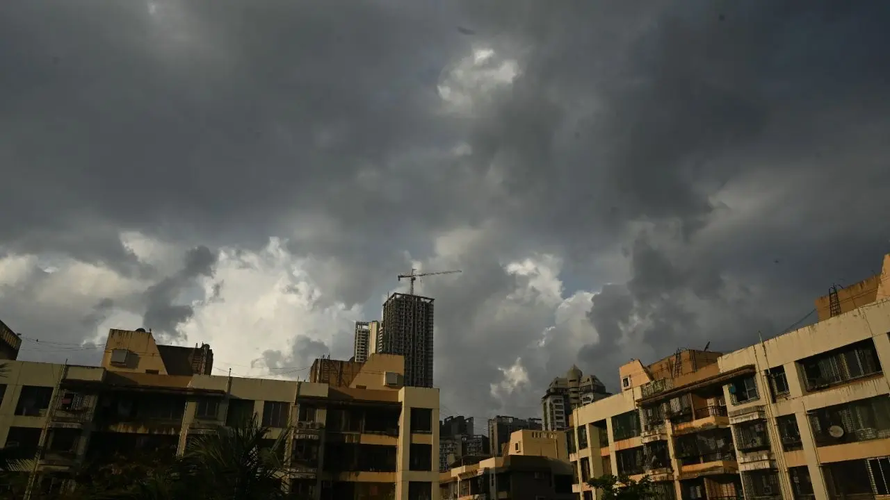Dark monsoon clouds hang over residential buildings in Thakur Village, signalling incoming showers across Mumbai Dark monsoon clouds hang over residential buildings in Thakur Village, signalling incoming showers across Mumbai