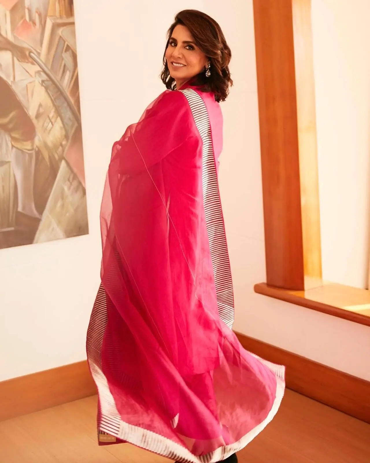 Neetu Kapoor looks absolutely radiant in this vibrant magenta ethnic ensemble, showcasing her signature grace and poise. The outfit features a flowing silk kurta paired with a sheer organza dupatta.
