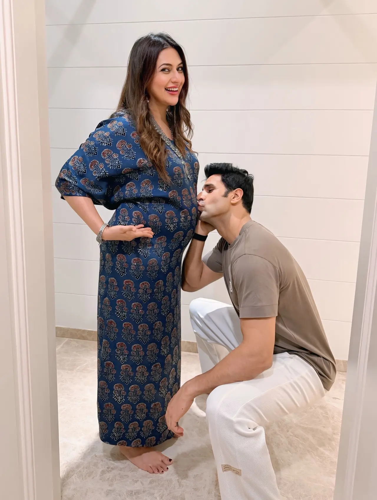 Divyanka Tripathi stunned in a blue printed flowy gown that beautifully highlighted her baby bump. The candid moment with her partner added warmth and charm to the stylish maternity shoot.