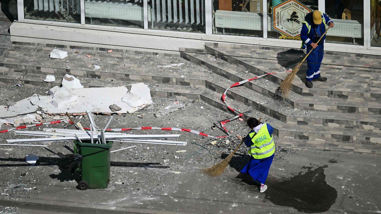 Municipal workers clear broken glass and debris from the streets of Galati after the explosion damaged homes and nearby buildings Municipal workers clear broken glass and debris from the streets of Galati after the explosion damaged homes and nearby buildings