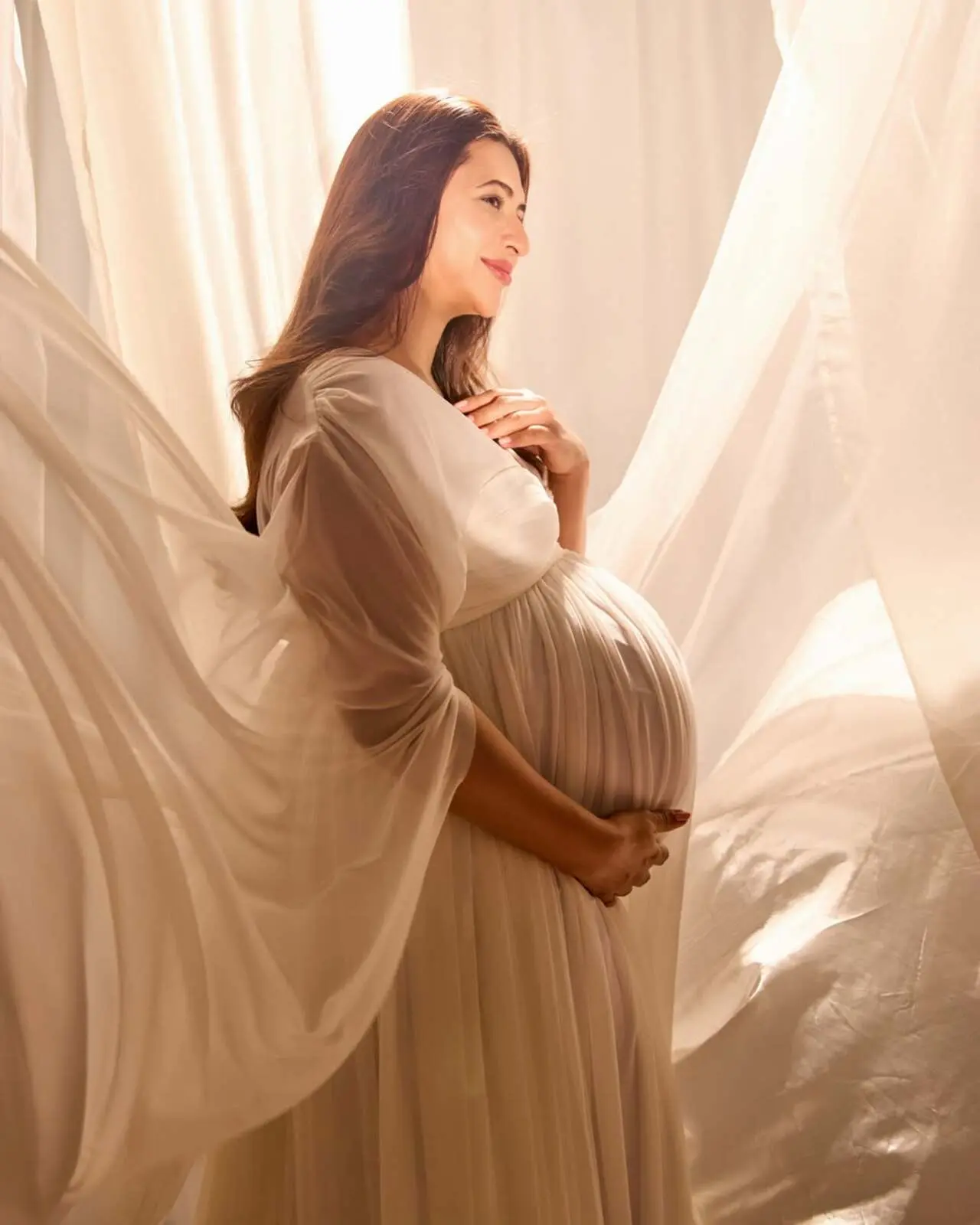 Before entering the next beautiful chapter of their lives, Divyanka and Vivek decided to get a dreamy maternity shoot done. Both of them were seen twinning in white in the photos, also placed against a white backdrop.