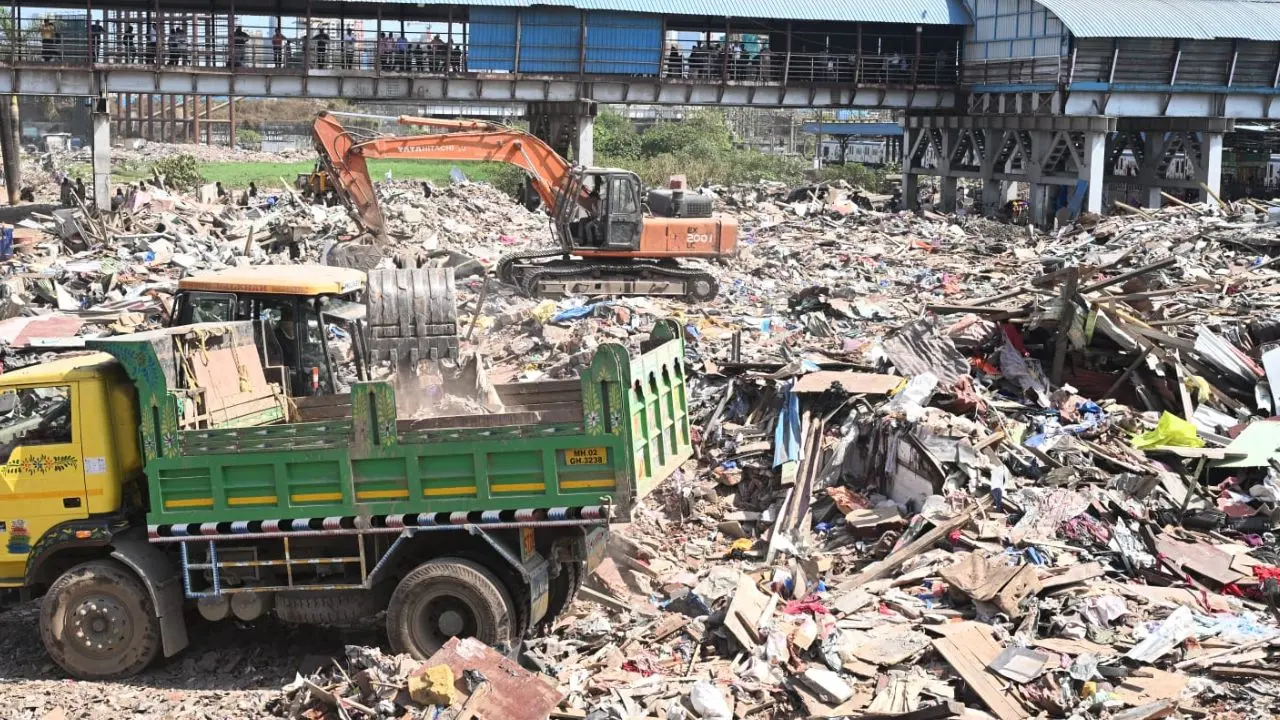 Post-demolition restoration work underway at Garib Nagar, with workers clearing debris and erecting boundary fencing in Bandra East Post-demolition restoration work underway at Garib Nagar, with workers clearing debris and erecting boundary fencing in Bandra East