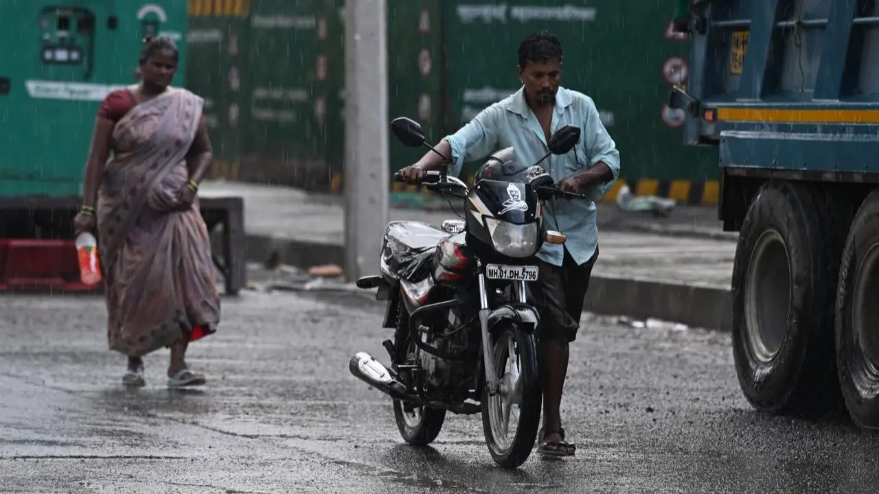 Commuters take shelter under flyovers and shop awnings as sudden downpour catches two-wheeler riders off guard Commuters take shelter under flyovers and shop awnings as sudden downpour catches two-wheeler riders off guard