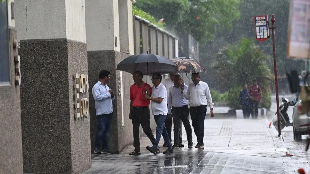 Commuters brave the first heavy downpour of the season as the rain sweeps through Wadala, blurring the city lines Commuters brave the first heavy downpour of the season as the rain sweeps through Wadala, blurring the city lines