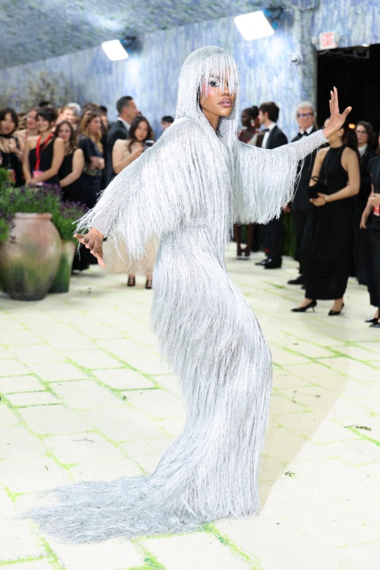 Teyana Taylor walked the red carpet wearing a custom Tom Ford gown by Haider Ackermann. Cut from fringed fabric, her silver dress featured a mysterious hood that nearly covered her face.