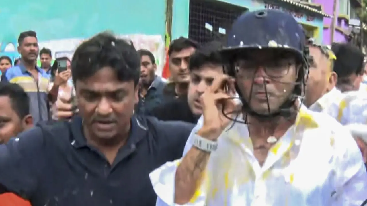 TMC General Secretary Abhishek Banerjee wears a helmet after stones, shoes, and eggs were hurled at him during his visit to the families of post-poll violence victims, in Sonarpur, West Bengal, on Saturday. PIC/PTI