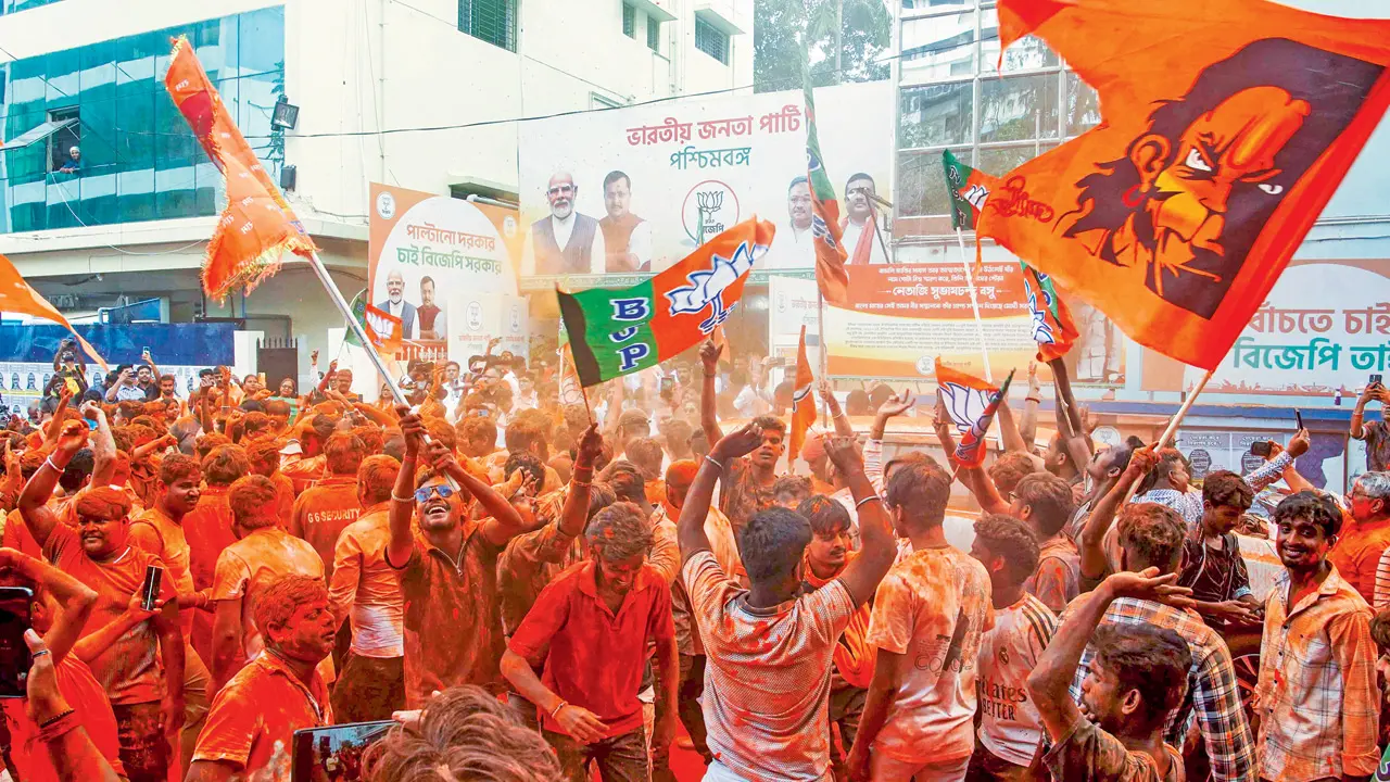 BJP supporters apply ‘gulal’ amid celebrations during vote tabulation of the West Bengal Assembly election results in Kolkata, on Monday. Pic/PTI