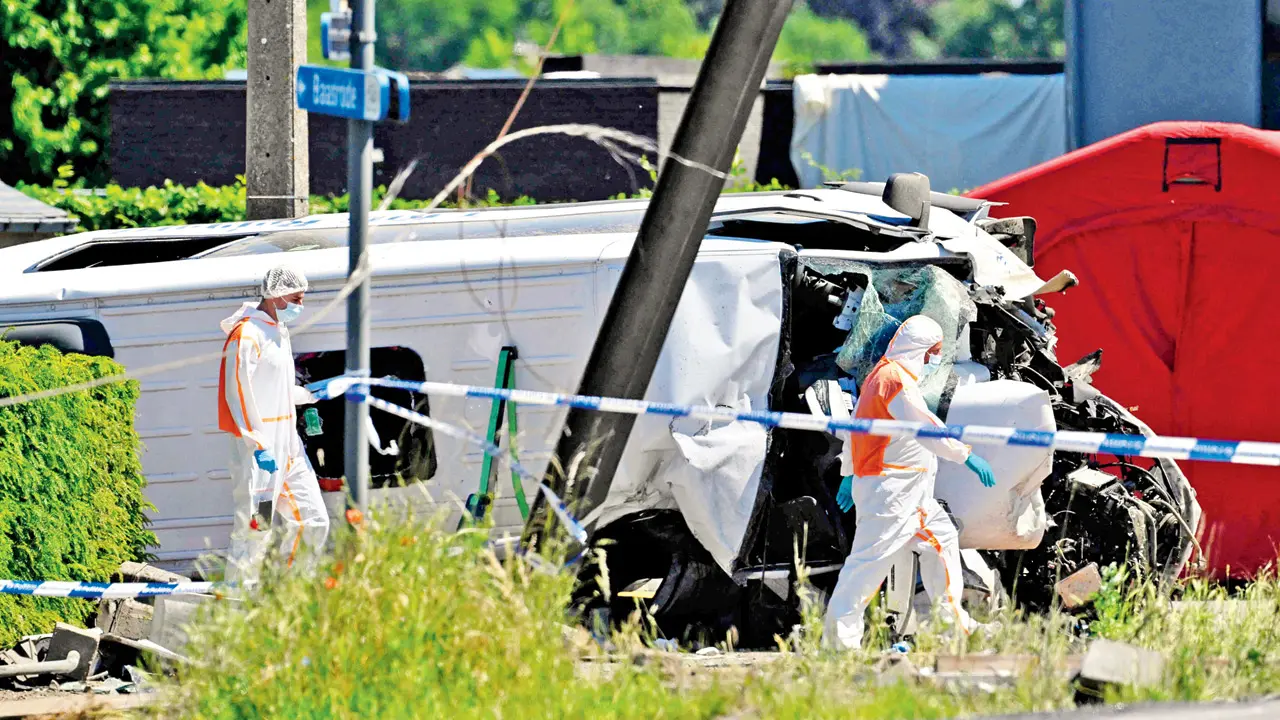 Belgium: Four killed, several hurt in train-bus collision Forensic Police officers inspect the accident site. PIC/AFP