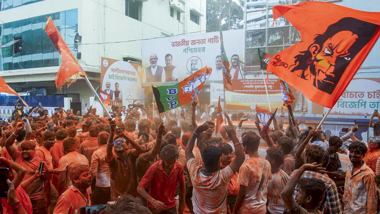  BJP supporters apply 'gulal' amid celebrations during vote tabulation on the day of West Bengal Assembly Election results, in Kolkata, on Monday. PIC/PTI