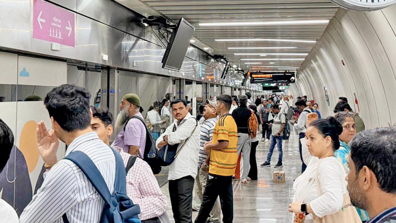 Commuters wait for delayed Aqua Line services at Marol Naka station amid prolonged disruptions and lack of updates from Metro authorities. Pic/Tarun Verma