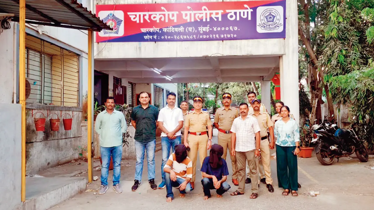 Safir Chaudhary and Waqar Ahmad Nazir Hussain (kneeling) with the Charkop police team after their arrest. Pics/By Special Arrangement