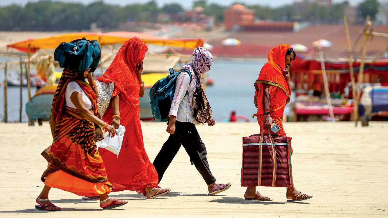 IMD issues heatwave alert for north and central India over next seven days People walk with their faces covered to protect themselves from the heatwave on a hot summer day, in Prayagraj on Thursday. Pic/PTI