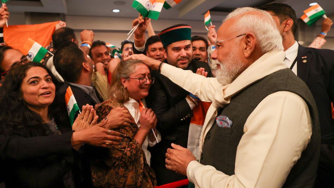 PM Modi greeted the Indian diaspora, shaking hands with diaspora members as the crowd cheered with 'Vande Mataram' and 'Modi, Modi..' slogans PM Modi greeted the Indian diaspora, shaking hands with diaspora members as the crowd cheered with 'Vande Mataram' and 'Modi, Modi..' slogans
