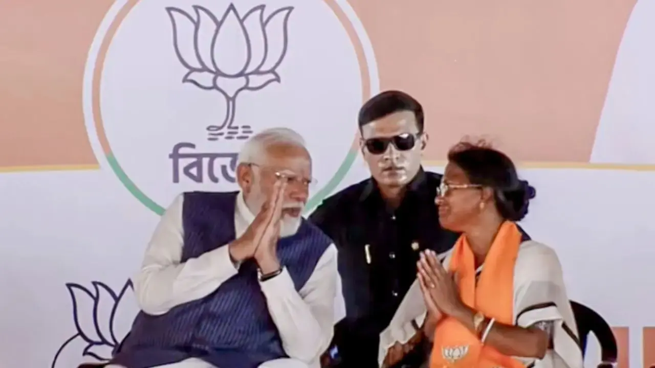 Ratna Debnath with PM Modi during a rally last month. FILE PIC