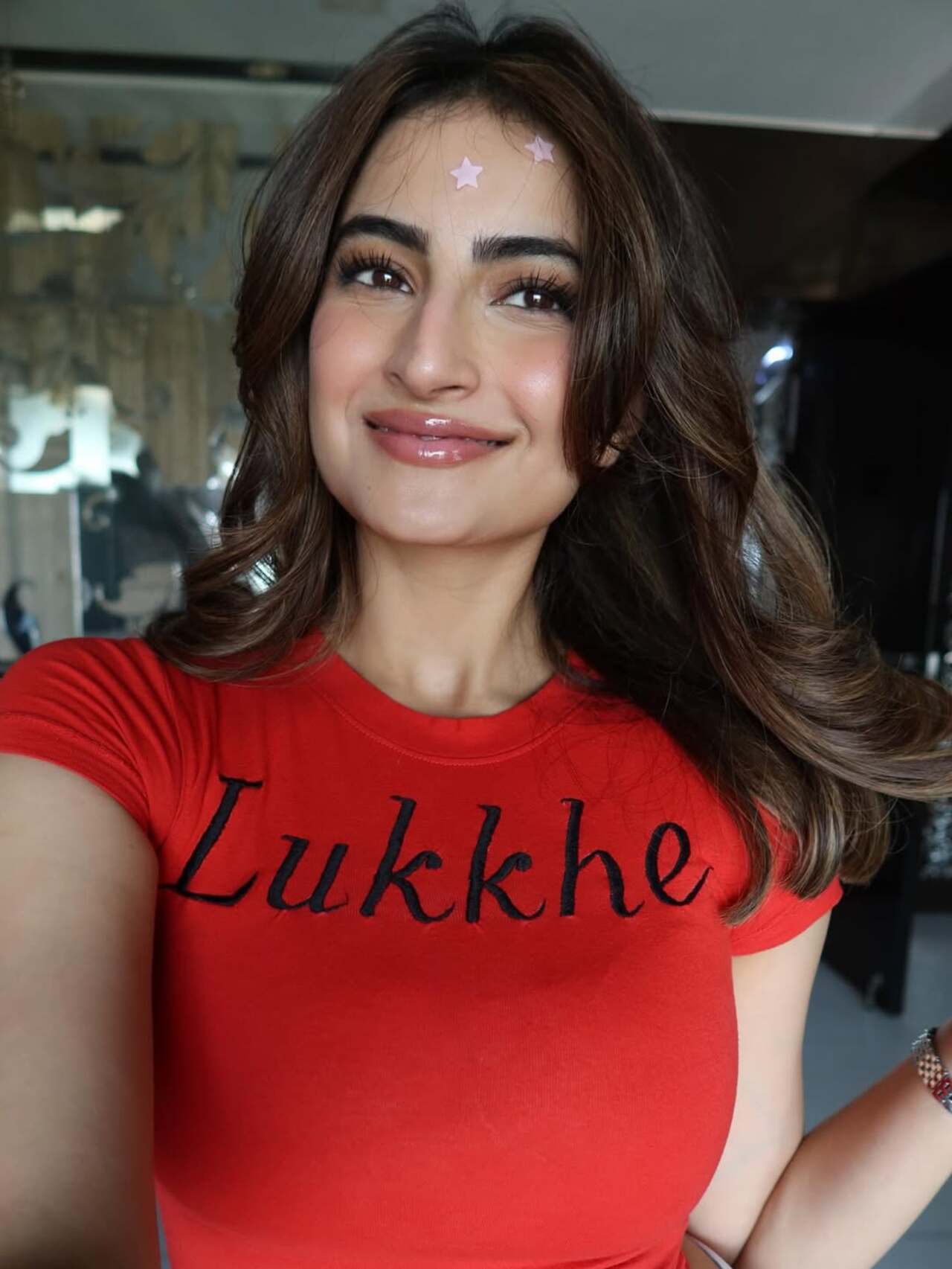 Palak Tiwari kept it playful and youthful in a fitted red graphic tee featuring Lukkhe branding. With glossy makeup, soft voluminous curls, and tiny star stickers on her forehead, the actor embraced vibrant vibe.