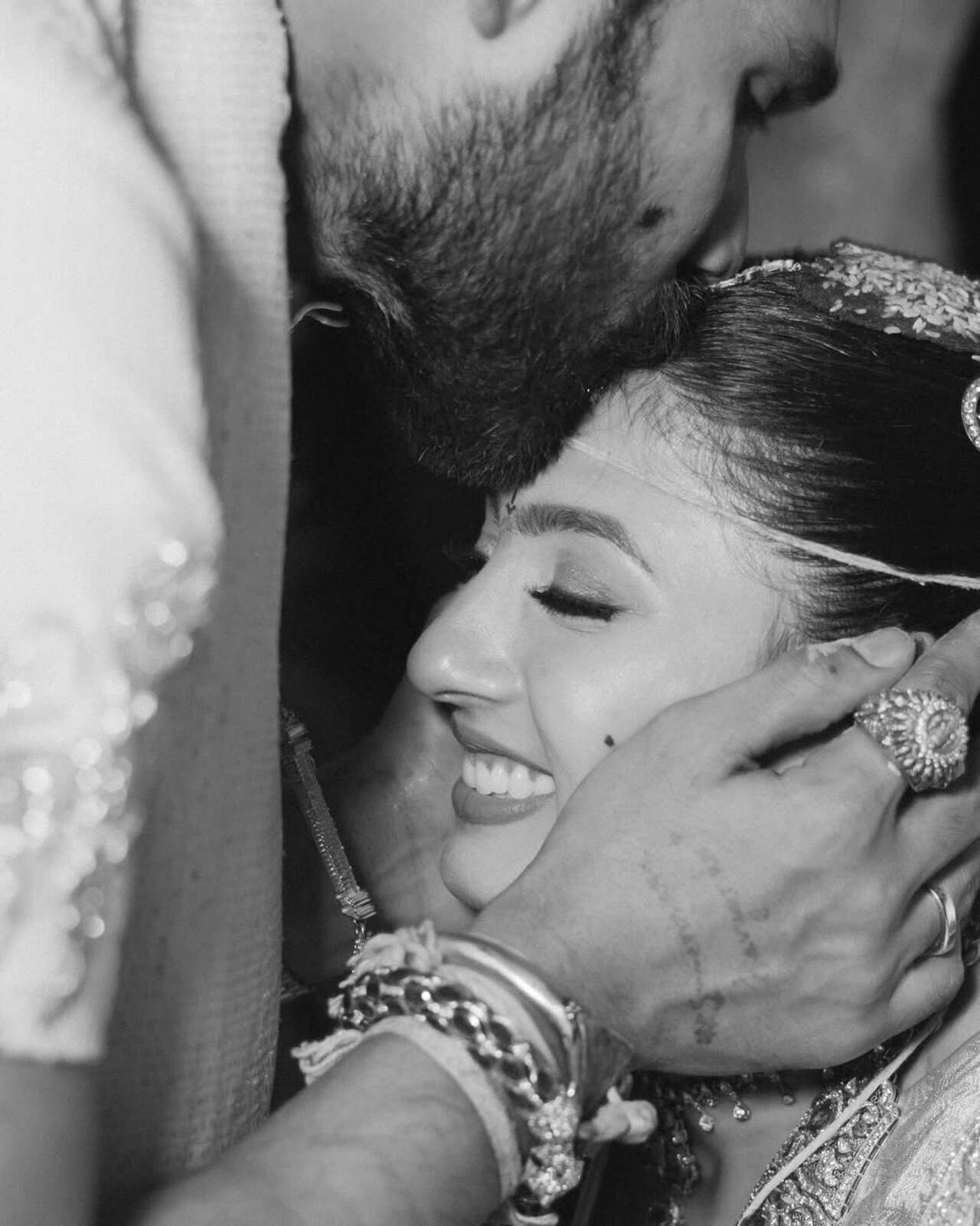 Bellamkonda Sreenivas shares a tender moment as he kisses Kavya Thapar, capturing an intimate and affectionate exchange.