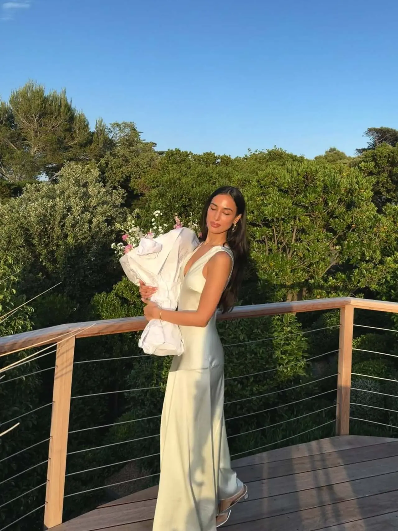 Mahieka Sharma is seen soaking in the golden-hour glow while holding a giant bouquet of flowers. Mahieka Sharma is seen soaking in the golden-hour glow while holding a giant bouquet of flowers.