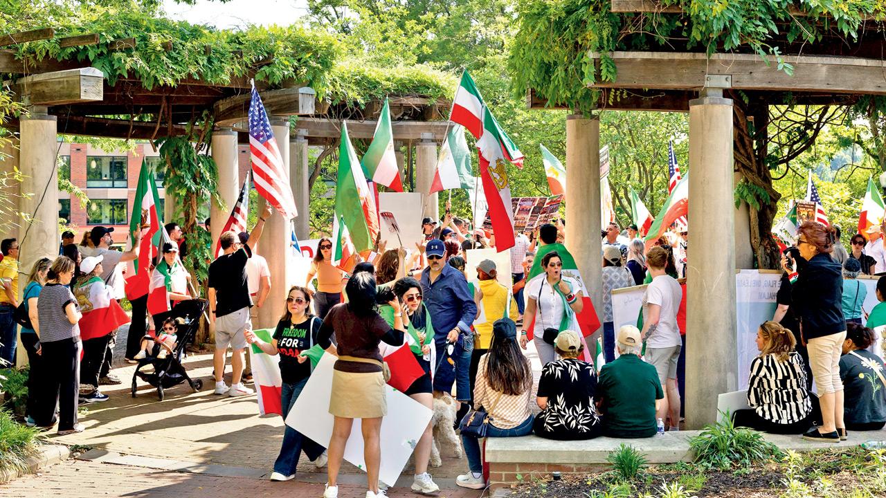 Demonstrators hold signs and flags during a rally in support of the Iranian people, in Washington, on Saturday. Pic/Getty Images