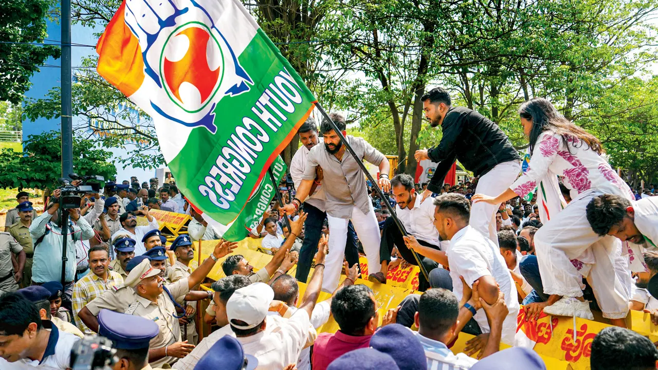 NEET re-test to be 100 per cent error-free, says Dharmendra Pradhan Karnataka Youth Congress President HS Manjunatha scales a barricade during a protest over the alleged irregularities in the NEET-UG medical entrance exam. Pic/PTI