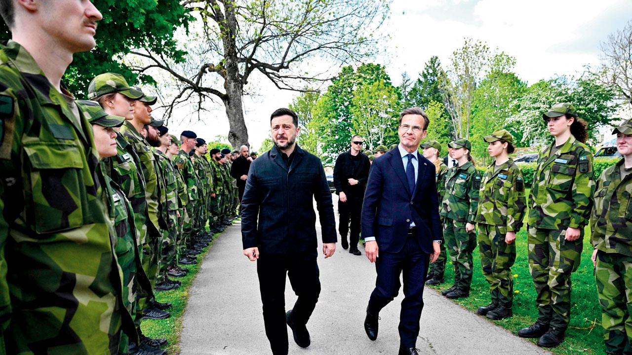 (From left) Ukraine’s President Volodymyr Zelenskyy and Swedish PM Ulf Kristersson inspect members of the Swedish armed forces. Pic/AFP