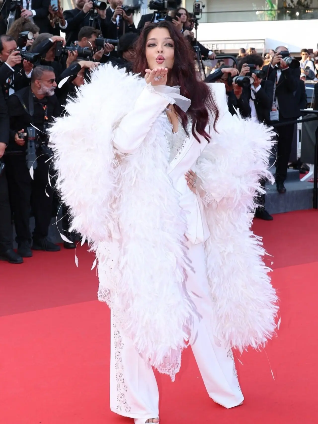 Aishwarya Rai Bachchan turned heads at Cannes 2026’s closing ceremony in a dramatic white pantsuit by Cheney Chan. Featuring feather detailing and sharp tailoring, the look received widespread praise online, further cementing her reputation as one of Cannes’ most celebrated fashion icons Aishwarya Rai Bachchan turned heads at Cannes 2026’s closing ceremony in a dramatic white pantsuit by Cheney Chan. Featuring feather detailing and sharp tailoring, the look received widespread praise online, further cementing her reputation as one of Cannes’ most celebrated fashion icons