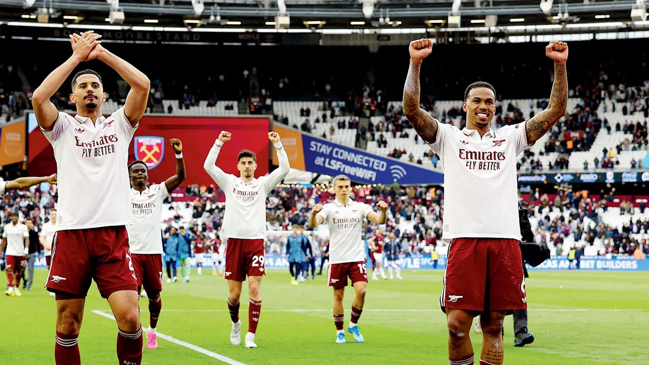 Gunners winners! Arsenal win the league after 22 years (Left) William Saliba and (right) Gabriel Magalhaes. Pics/AFP