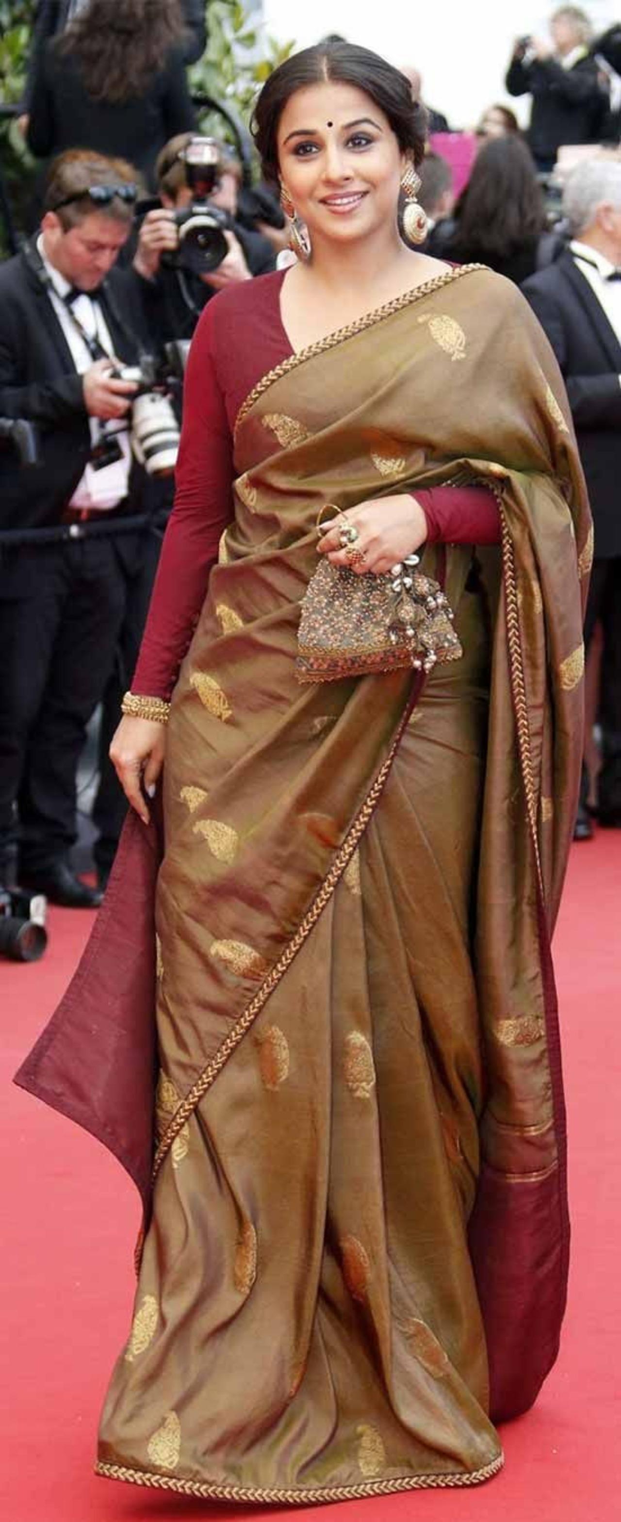 Vidya wore a brown Tussar silk saree paired with a full-sleeve maroon blouse. The saree was designed by Sabyasachi Mukherjee for her appearance at the 66th Cannes Film Festival in 2013.