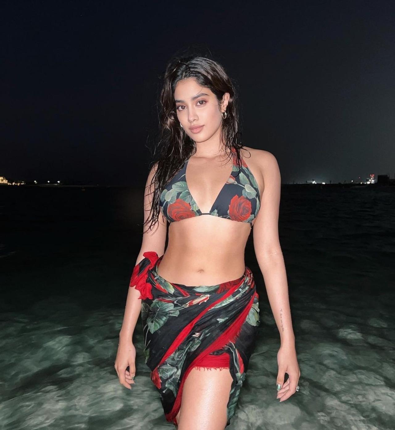 Janhvi Kapoor brought vintage charm to her bikini in this black and red floral print bikini top and matching sarong. Janhvi Kapoor brought vintage charm to her bikini in this black and red floral print bikini top and matching sarong.