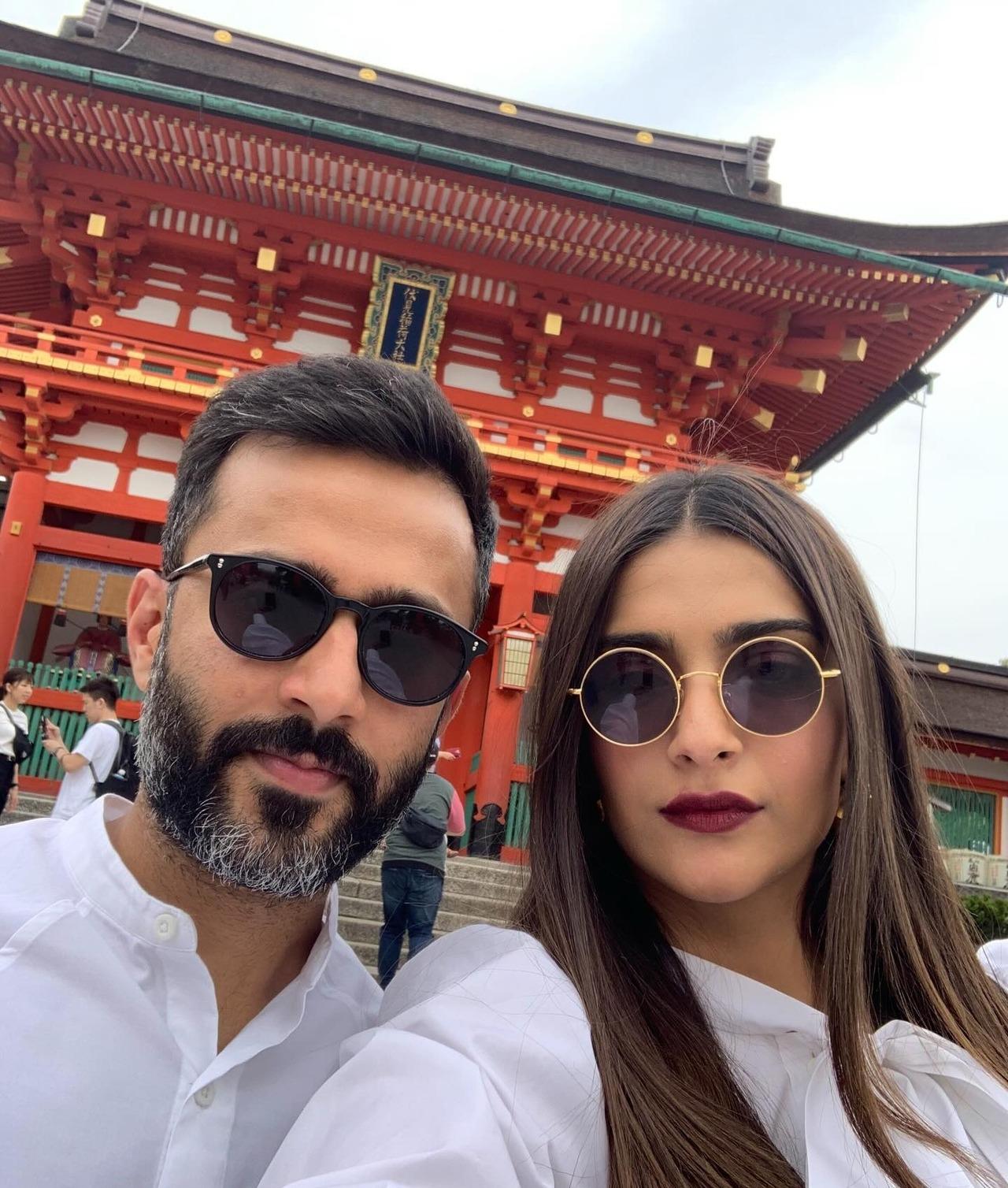 Sonam's mother-in-law shared a picture of the couple from their vacation to Fushimi Inari Shrine in Kyoto, Japan. They are seen wearing matching white outfits with sunglasses, while Sonam brings in the glam with her dark burgundy lips. Sonam's mother-in-law shared a picture of the couple from their vacation to Fushimi Inari Shrine in Kyoto, Japan. They are seen wearing matching white outfits with sunglasses, while Sonam brings in the glam with her dark burgundy lips.