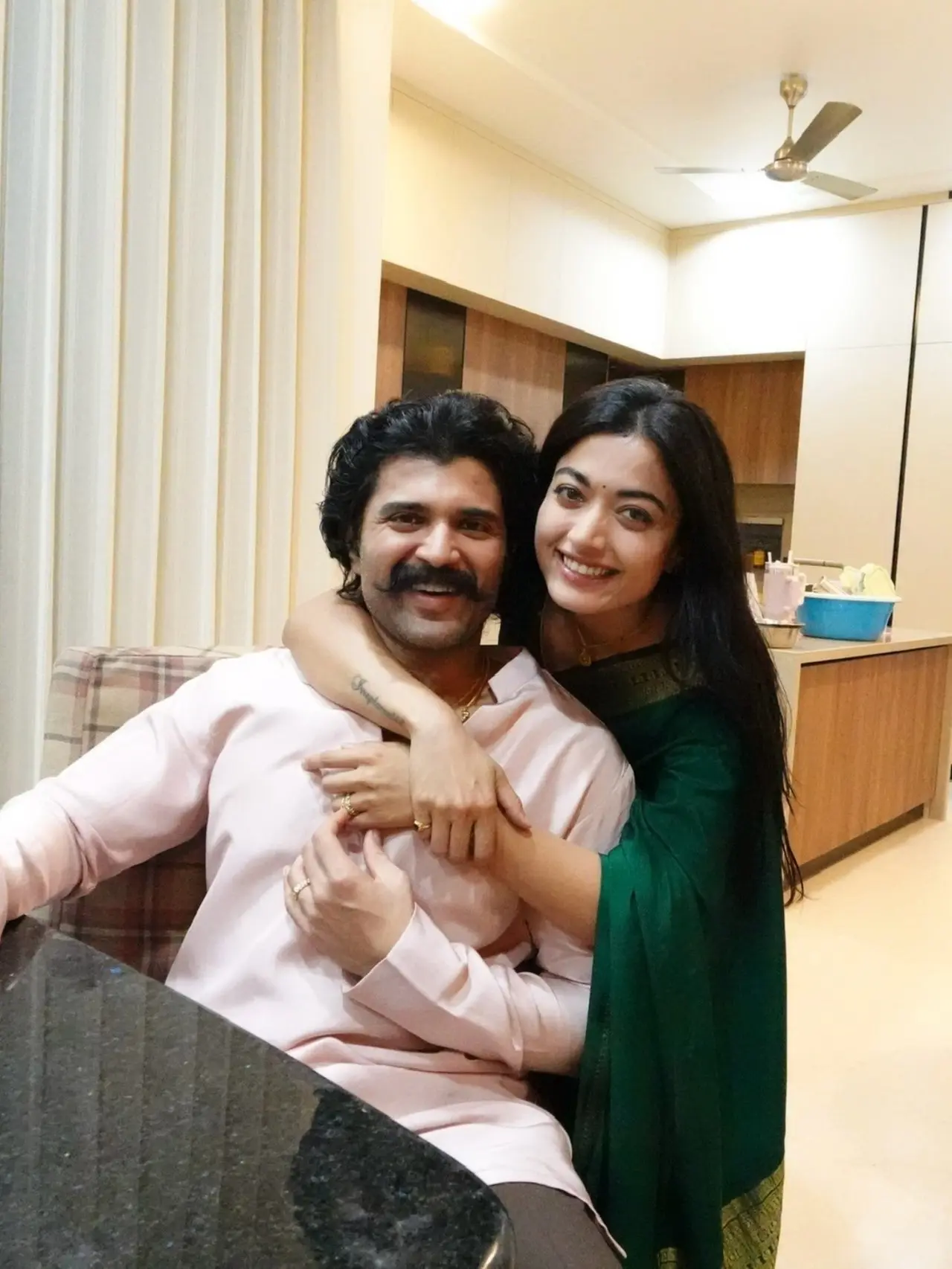 Rashmika Mandanna was seen hugging birthday boy, Vijay Deverakonda, from behind as he sat at a table. Rashmika Mandanna was seen hugging birthday boy, Vijay Deverakonda, from behind as he sat at a table.