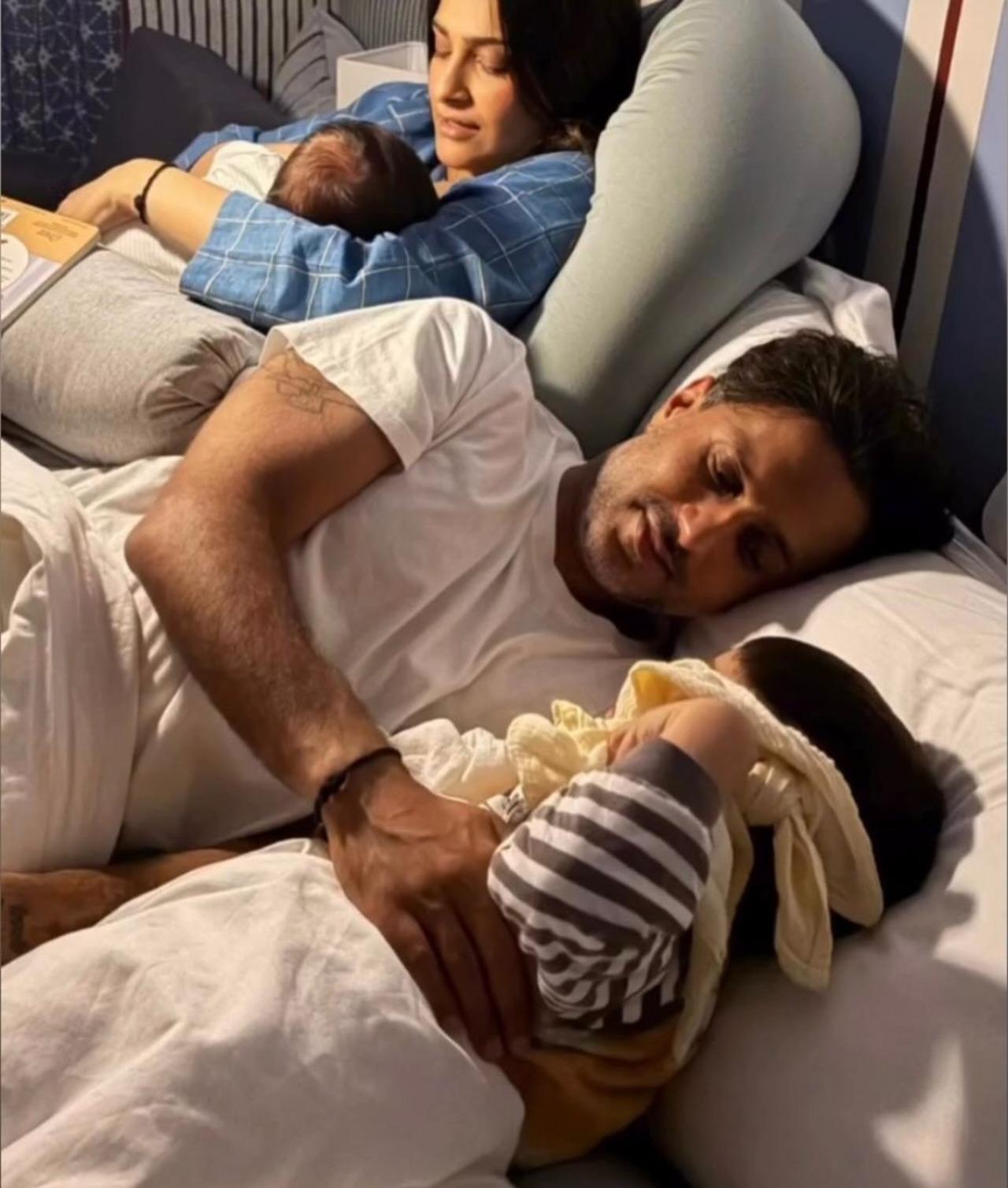 This picture shows Anand and Sonam busy taking care of their kids in bed. While Sonam feeds their newborn son, Anand takes care of Vayu. This picture shows Anand and Sonam busy taking care of their kids in bed. While Sonam feeds their newborn son, Anand takes care of Vayu.