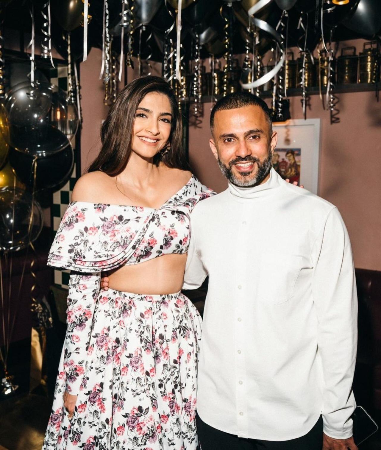 Sonam wears a pretty summer outfit as she poses with Anand, who wears a white shirt, in this picture, seemingly taken at a party. Sonam wears a pretty summer outfit as she poses with Anand, who wears a white shirt, in this picture, seemingly taken at a party.